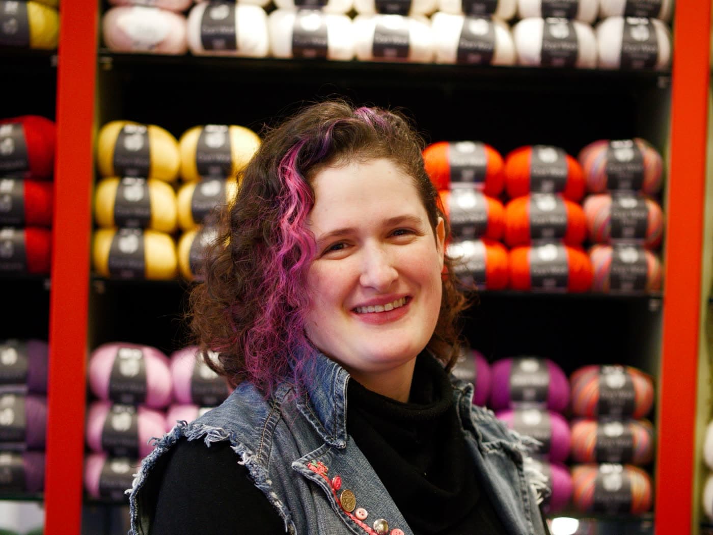 Deborah Kohlhöfer, Inhaberin des Ilse Wollmarkt, vor den Garnregalen